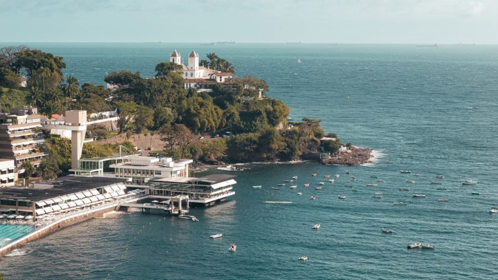 A breathtaking view of Salvador's coastline with lush greenery and tranquil ocean waters.